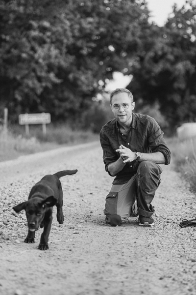 Fotografen Björn på en landsväg med sin hundvalp Fotografen Björn på en landsväg med sin hundvalp